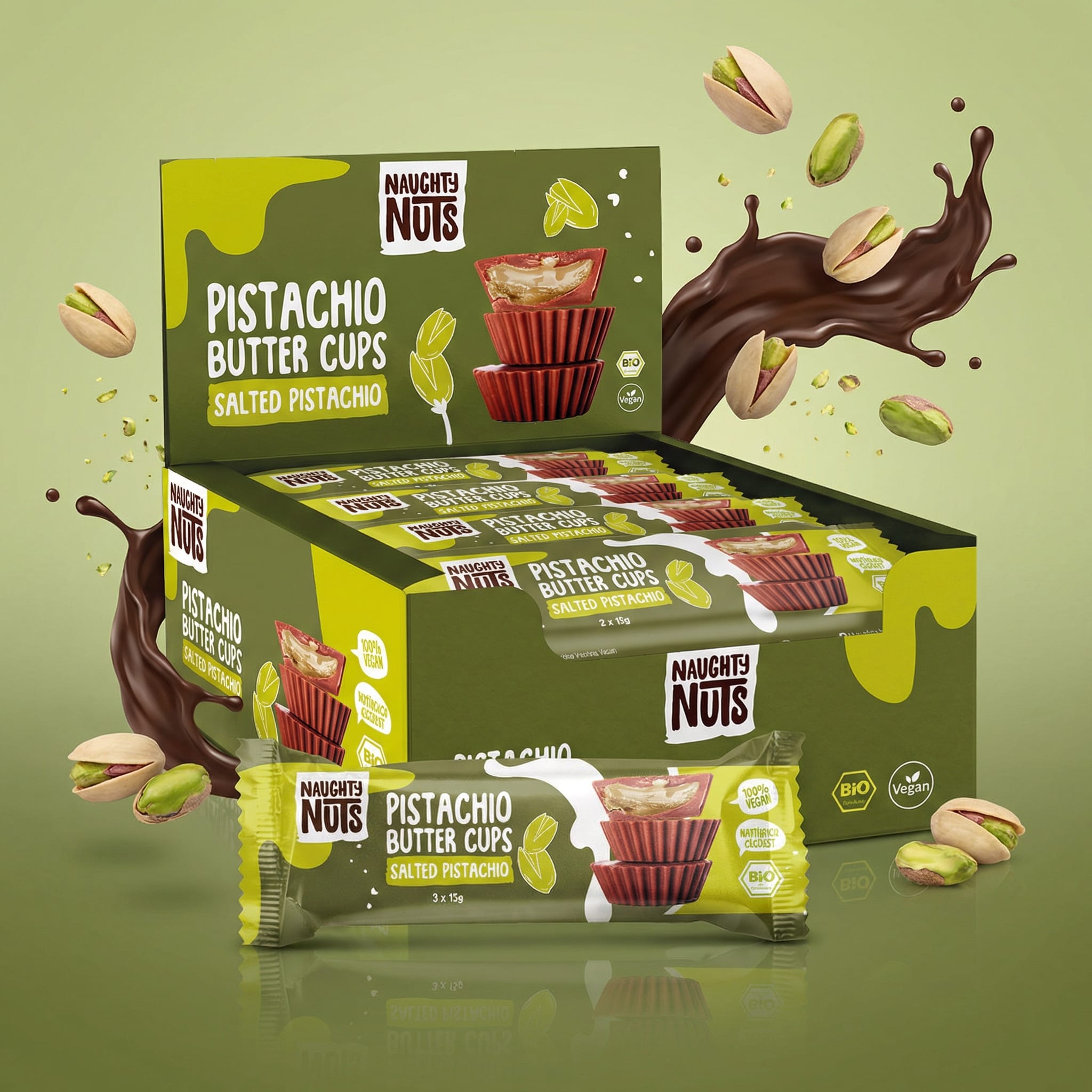 Bio Pistazienbutter Cups Salted Pistachio in Verpackung mit Schokoladenspritzern und Pistazien
